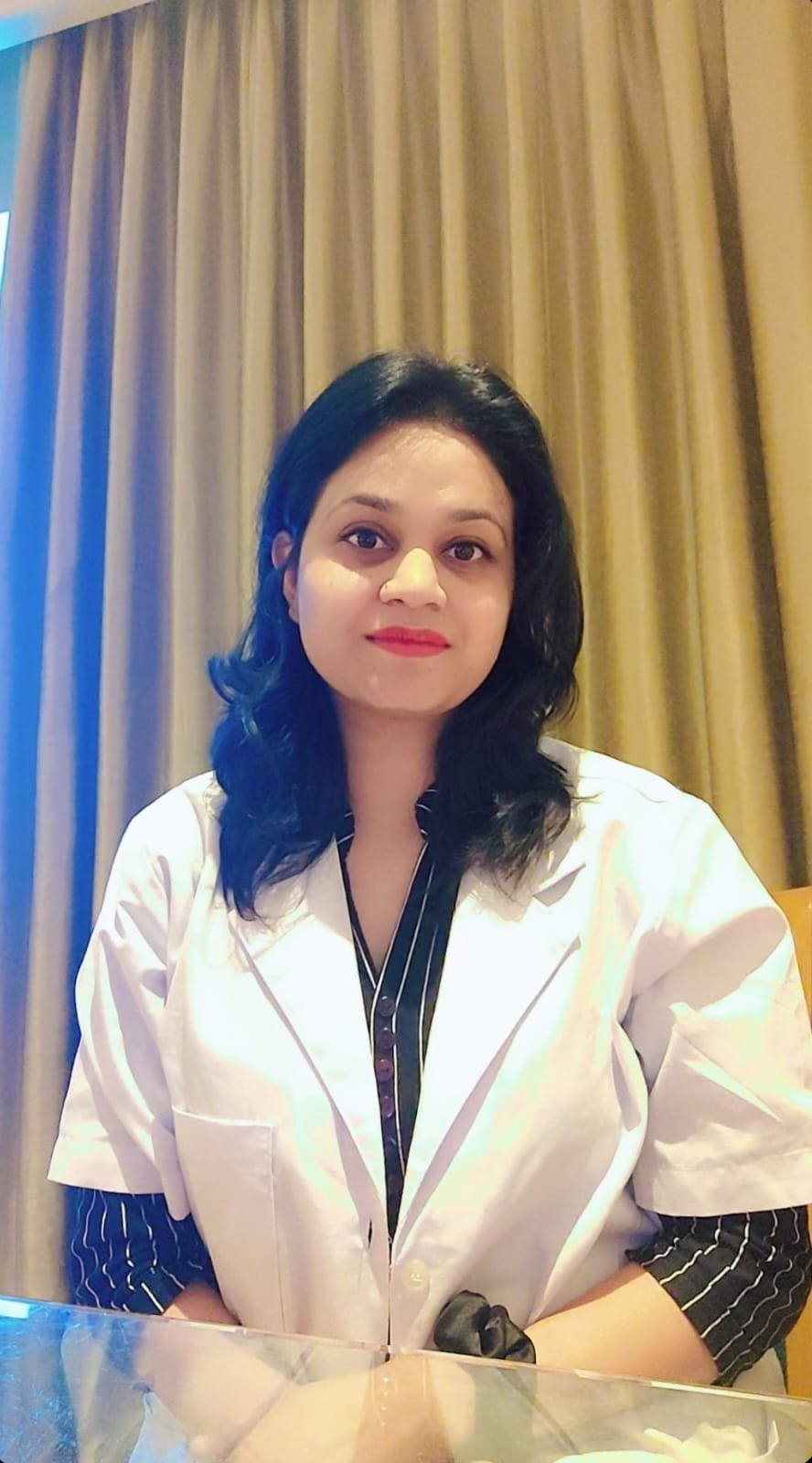 Professional female nutritionist in white coat with friendly smile